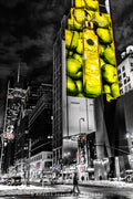 Bright yellow-green illuminated advertising above pedestrians in Times Square, New York. Photograph by Anders Jorulf.