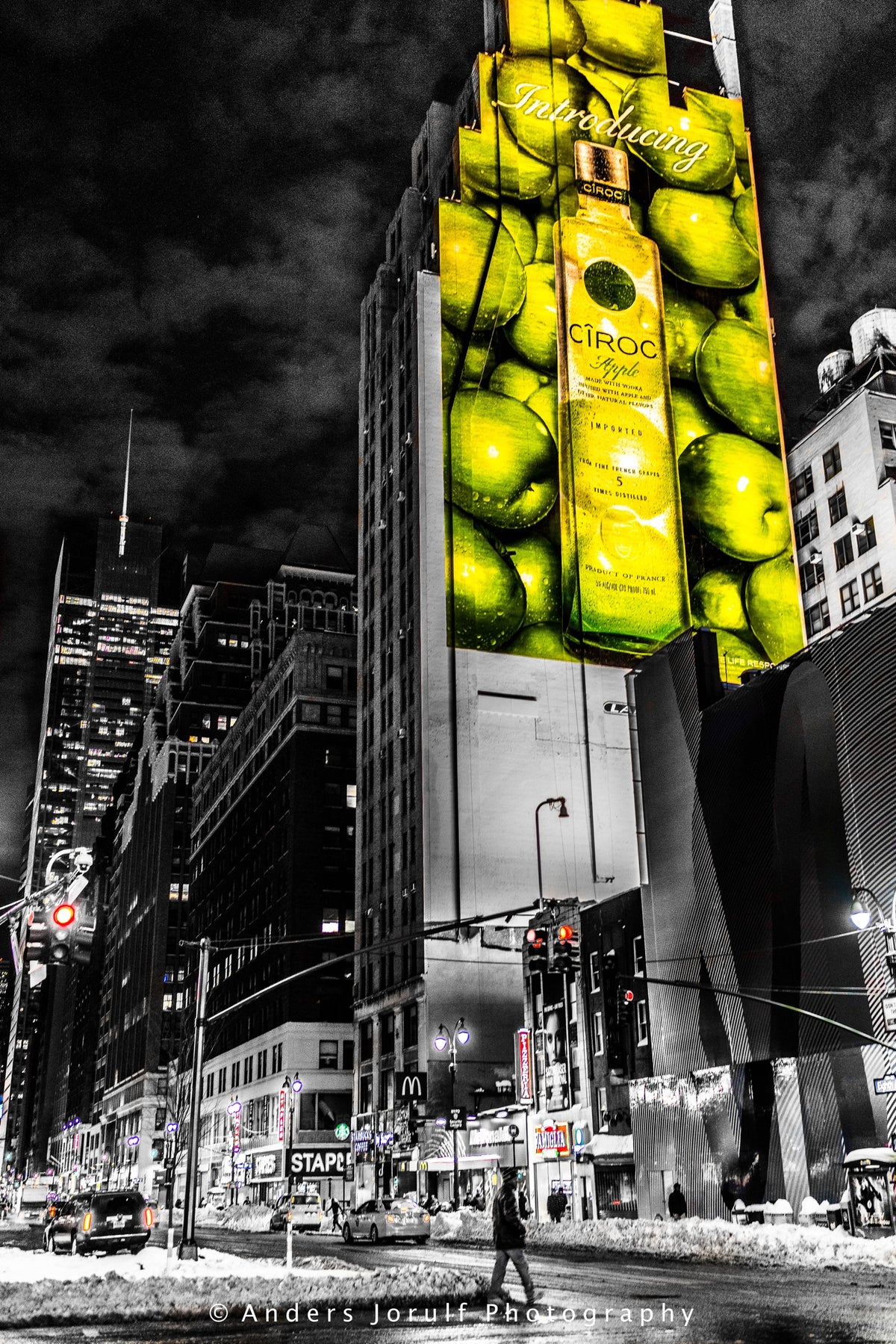Bright yellow-green illuminated advertising above pedestrians in Times Square, New York. Photograph by Anders Jorulf.