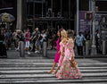Two pedestrians in colourful clothing crossing a New York street against a darker urban background. Photograph by Anders Jorulf.