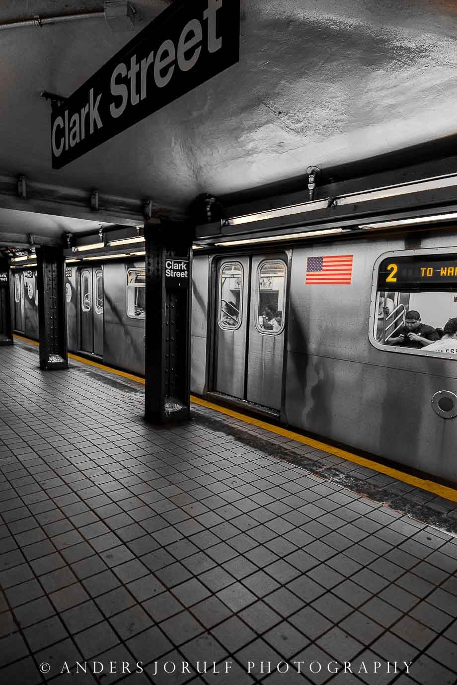 A subway train and platform beneath a 14 Street sign in New York. Photograph by Anders Jorulf.
