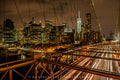 Light trails on Brooklyn Bridge beneath an illuminated Manhattan skyline. Photograph by Anders Jorulf.