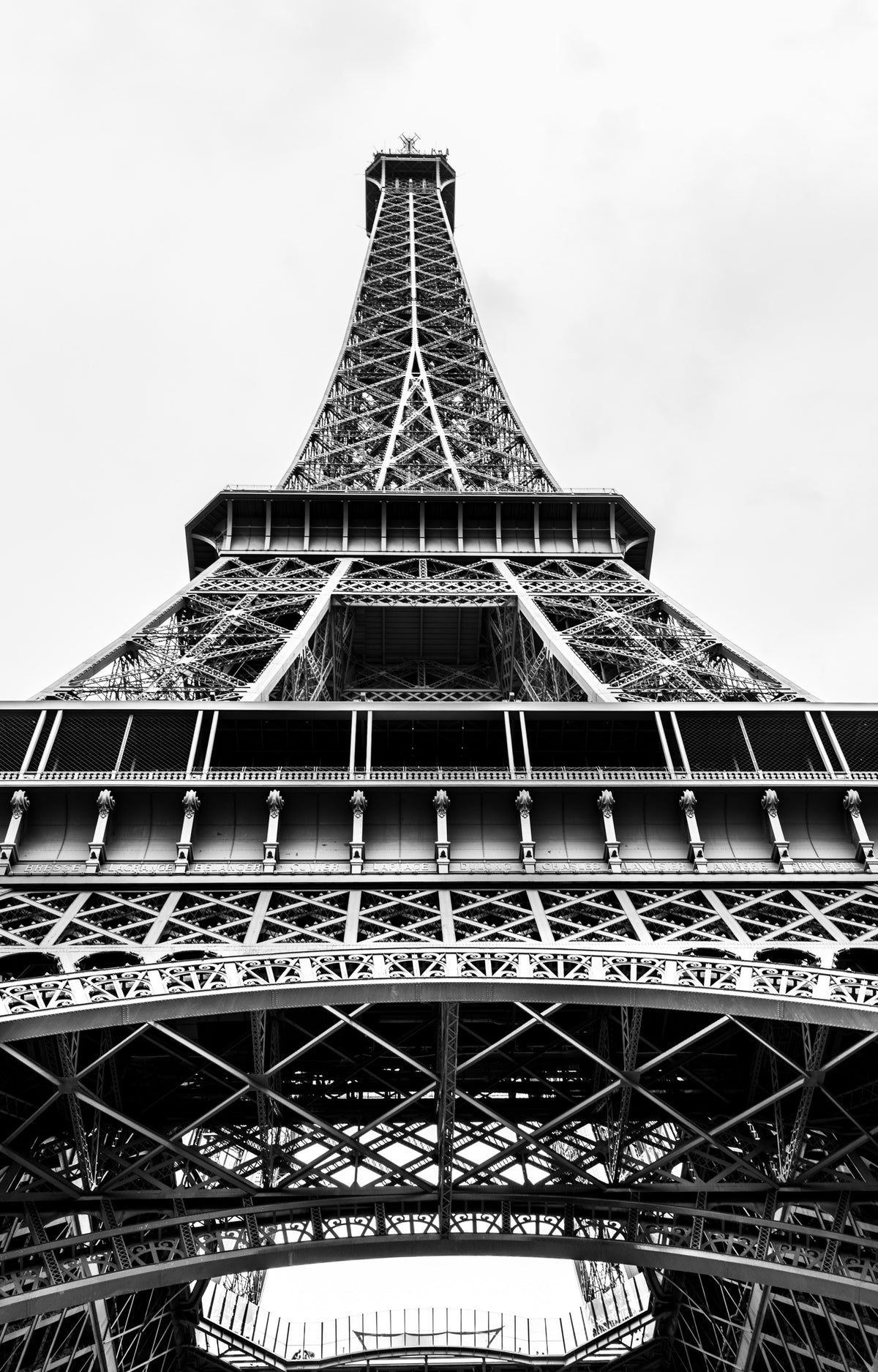 A black-and-white view looking upwards along the Eiffel Tower’s iron structure. Photograph by Anders Jorulf.